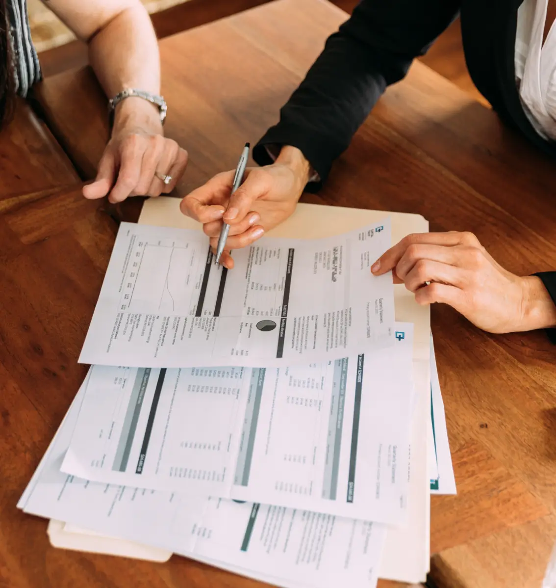 Two people analyzing paperwork together
